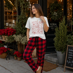 Woman wearing the All Booked for Christmas Comfort Colors 1717 holiday graphic tee with cozy festive outfit