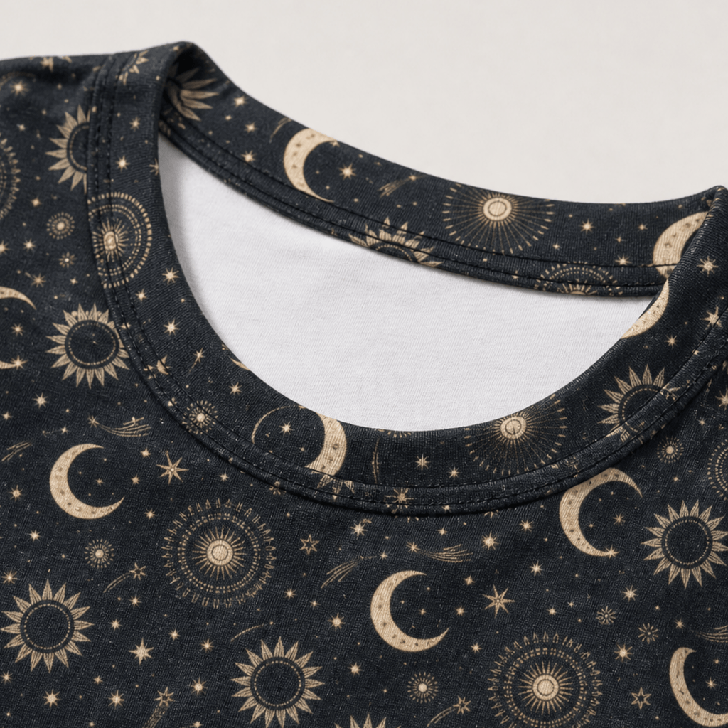 Close-up of the celestial moon and sun all-over print on a women's crop tee showing the detailed astrology design.