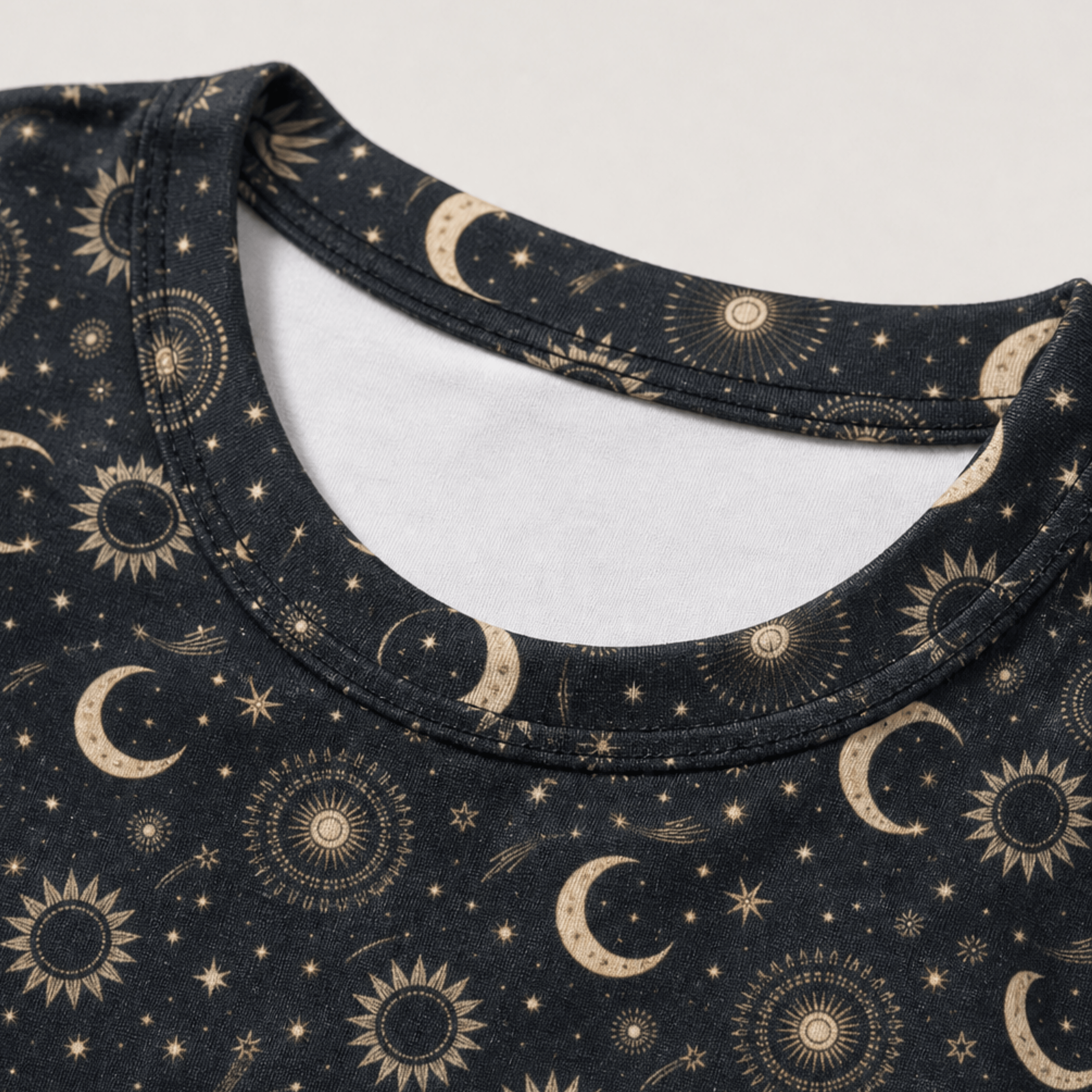 Close-up of the celestial moon and sun all-over print on a women's crop tee showing the detailed astrology design.