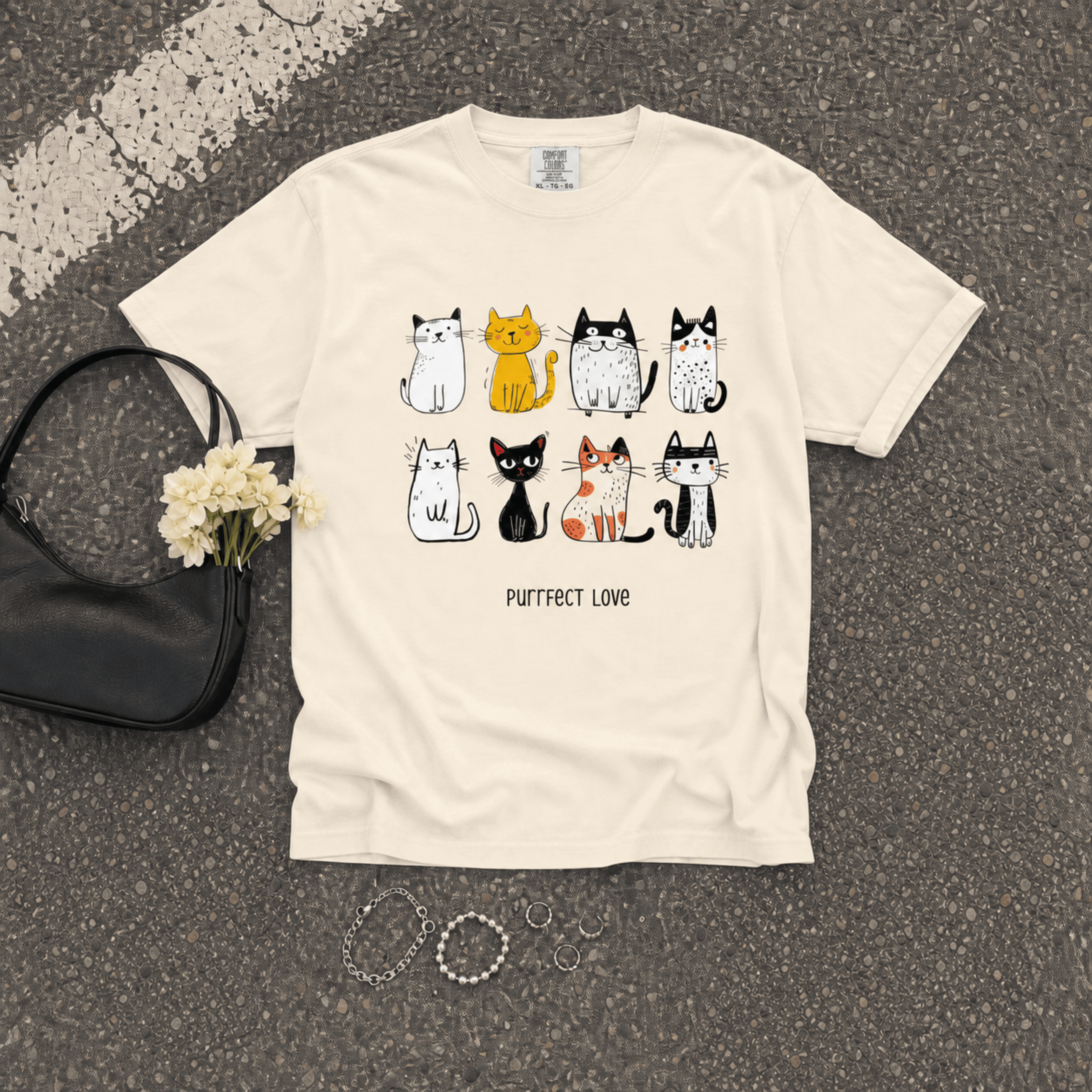 Flat lay of the Purrfect Love Comfort Colors 1717 cat graphic T-shirt showcasing the cute cat illustration and relaxed fit.